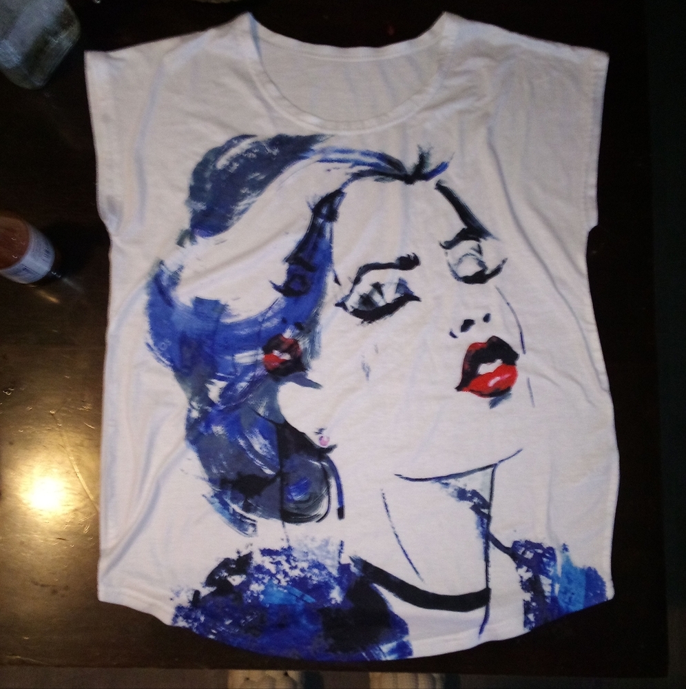 A large white shirt with a painted woman on the front.